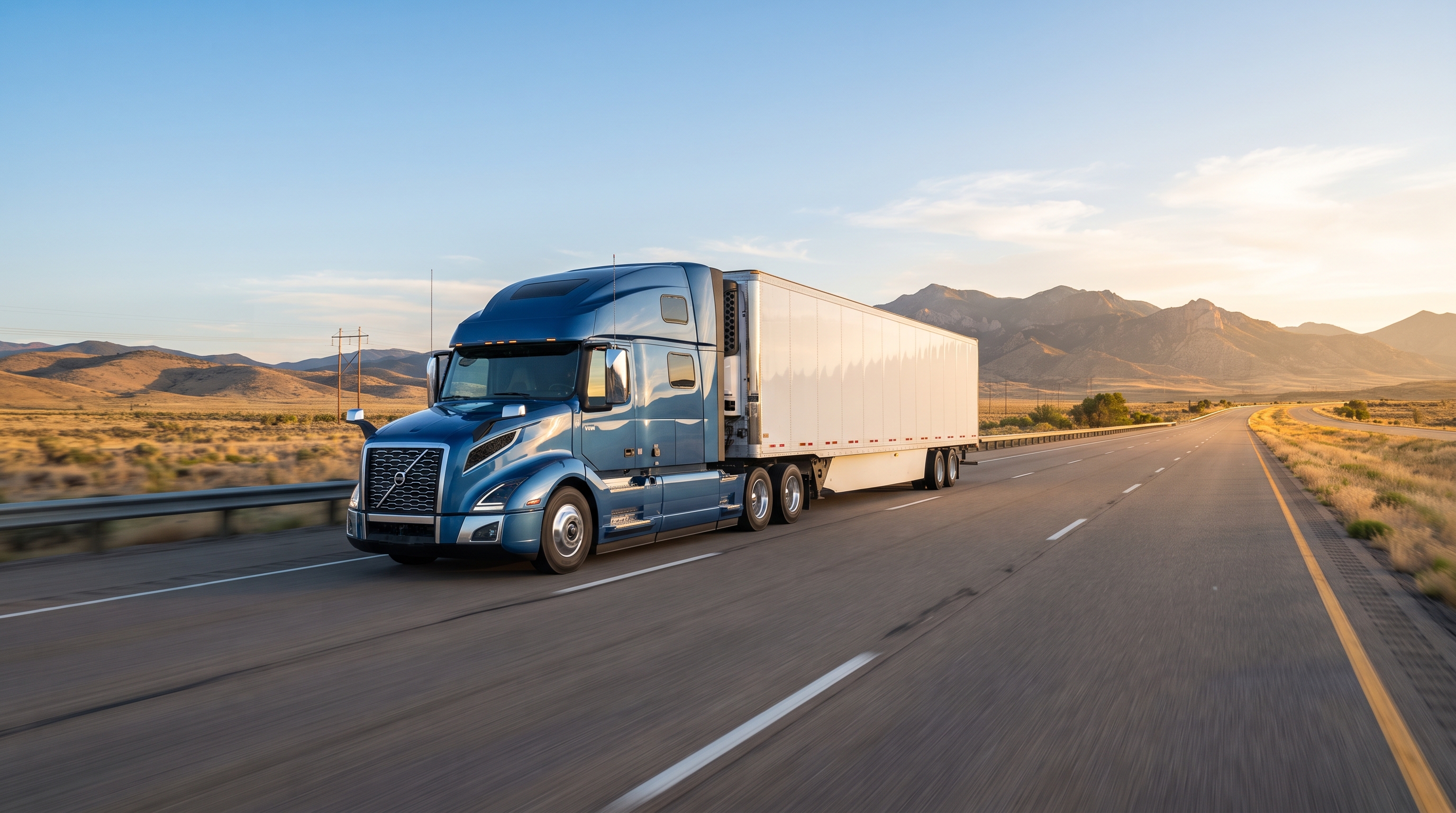 ASA Transport semi-truck driving on an open highway at sunrise